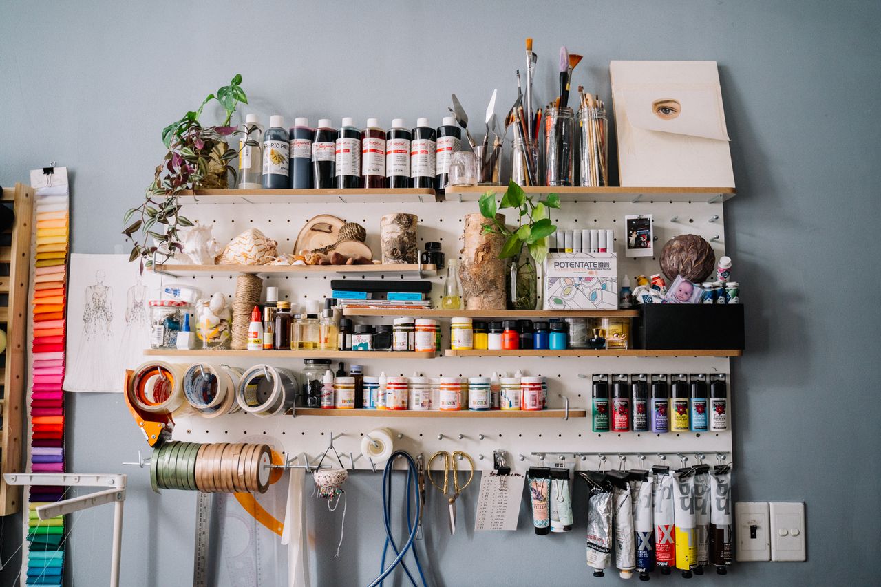A colorful arrangement of art supplies on a wooden shelf, ideal for creative workshops and studios.
